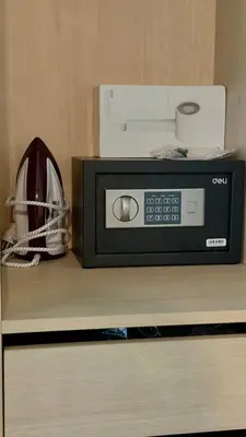 a microwave sitting on top of a shelf with a helmet at Fantasea Kamala Beach 1 BR 313 in Kamala Beach
