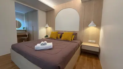 a bedroom with a large bed with yellow pillows at Fantasea Kamala Beach 1 BR 313 in Kamala Beach