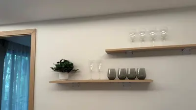 a shelf with glasses and vases on a wall at Fantasea Kamala Beach 1 BR 313 in Kamala Beach