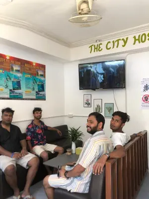 a group of men sitting in a waiting room at The City Hostel in Phi Phi Don