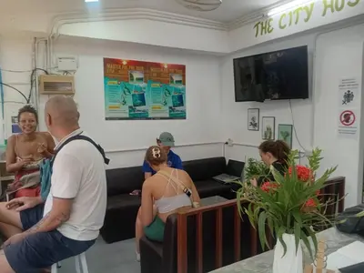 a group of people sitting in a waiting room at The City Hostel in Phi Phi Don