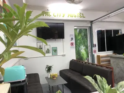 a living room with a couch and a table at The City Hostel in Phi Phi Don