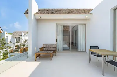 a balcony with a wooden bench and a table at V183 Lux Pride Villas 3BR Private Pool Retreat in Bang Tao Beach