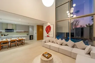 a living room with a white couch and a table at V183 Lux Pride Villas 3BR Private Pool Retreat in Bang Tao Beach
