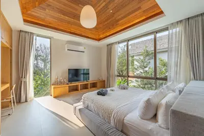 a bedroom with a large bed and a large window at V183 Lux Pride Villas 3BR Private Pool Retreat in Bang Tao Beach
