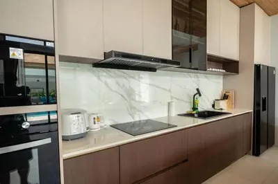 a kitchen with a sink and a counter top at Mouana Breeze Maikhao VIP 4-bedroom Pool Villa 9916 in Mai Khao Beach
