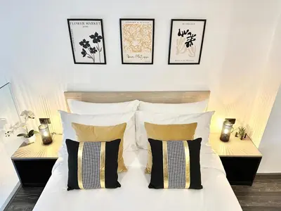 a bedroom with a bed with pillows and two tables at C181 Stylish 1BR Loft Near Naiharn Beach Pool Gym in Rawai Beach
