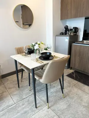 a dining room table with chairs and a mirror at C181 Stylish 1BR Loft Near Naiharn Beach Pool Gym in Rawai Beach