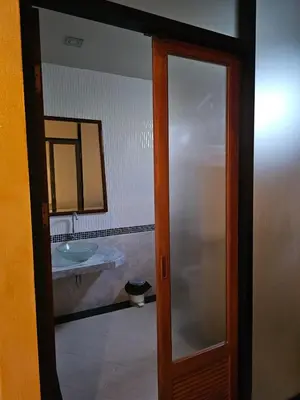 a bathroom with a sink and a mirror at The house on the hill in Ban Na Kok