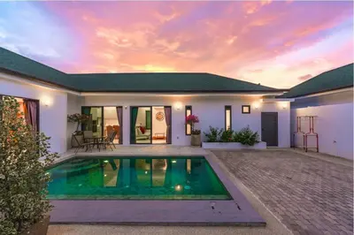 a villa with a swimming pool in front of a house at V193 Next-Door Villas 6BR 2 Pools For Group Vibe! in Rawai Beach