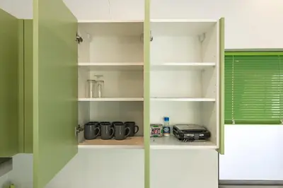 a pantry with green walls and shelves with a toaster at V193 Next-Door Villas 6BR 2 Pools For Group Vibe! in Rawai Beach