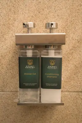 two bottles of soap sitting on a shelf at Green Garden Villa Hotel in Nai Harn Beach