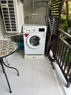 a washing machine sitting on a porch next to a table at Title Rawai Phase III By Mill 1 fl in Rawai Beach