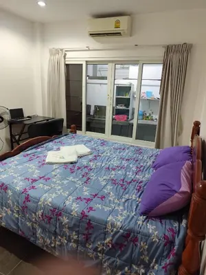 a bedroom with a bed with a book on it at Maison local avec terrasse et cuisine extérieure Proche Patong in Kathu