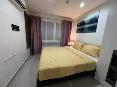 a bedroom with a large bed in a room at Plus 1 Condo 202-67 in Kathu