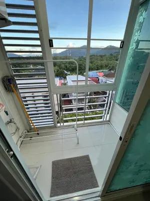 a room with a large window and a view of a balcony at Plus 1 Condo 202-67 in Kathu