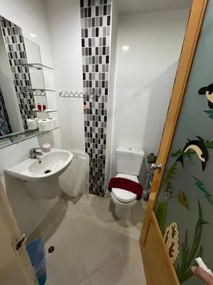 a bathroom with a toilet and a sink at Plus 1 Condo 202-67 in Kathu