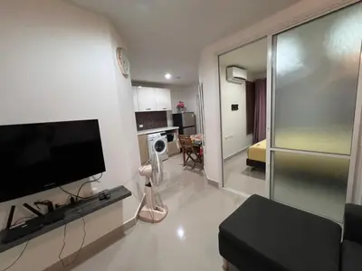 a living room with a flat screen tv on a wall at Plus 1 Condo 202-67 in Kathu