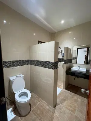 a bathroom with a toilet and a sink at J&B House in Nai Yang Beach