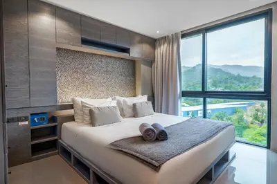 a bedroom with a large bed with a large window at Great 1BDR Kamala 500m to beach in Kamala Beach