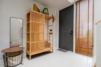 a room with a black door and a table and a stool at ORIGINAL DESIGNED 2BR TownHouse6 MonkeyHill in Ban Sam Kong