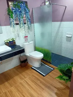 a bathroom with a toilet and a shower at 9 Home Phuket in Ban Rangeng