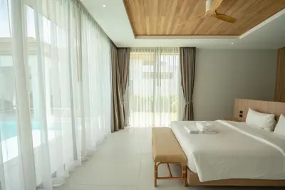 a bedroom with a bed and a large window at Mouana Breeze Maikhao 3-bedroom Pool Villa 9917 in Mai Khao Beach