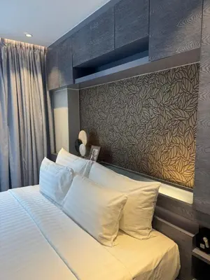 a bedroom with a large bed with a wall at C182 Kamala 1BR Stay Near Beach & Attractions in Kamala Beach