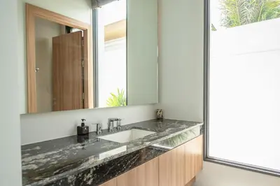 a bathroom with a sink and a mirror at Mouana Breeze Mai Khao 4-bedroom Pool Villa 9925 in Mai Khao Beach