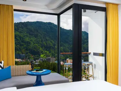 a bedroom with a view of a mountain at TRIBE Phuket Patong by Accor in Patong Beach