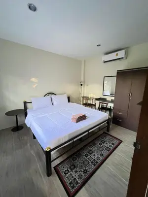 a bedroom with a bed and a projection screen at Fran Sim Da Guest House in Bang Tao Beach