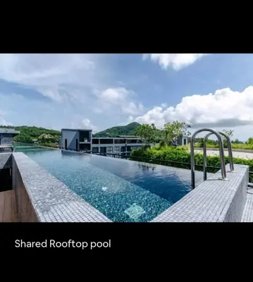a swimming pool in front of a building at City Gate Apartments Kamala Beach Phuket Thailand - LMY in Kamala Beach