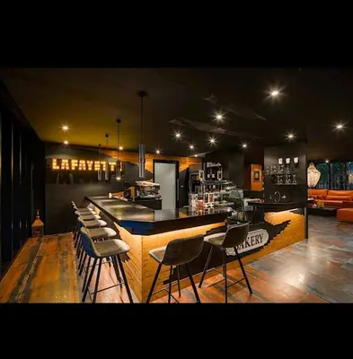 a kitchen with a bar with chairs around it at City Gate Apartments Kamala Beach Phuket Thailand - LMY in Kamala Beach