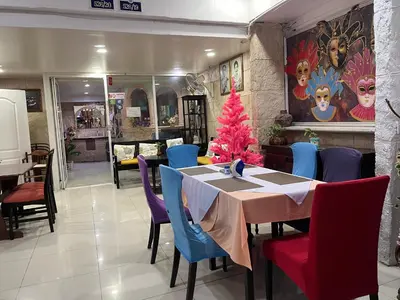 a dining room with a christmas tree on a table at Da Mario Hotel & Restaurant in Karon Beach