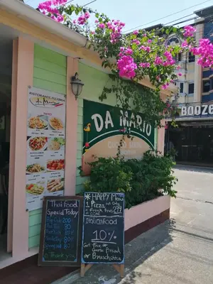 a restaurant with a sign on the side of a building at Da Mario Hotel & Restaurant in Karon Beach