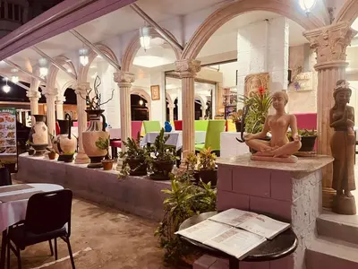 a store with a statue of a woman sitting on a table at Da Mario Hotel & Restaurant in Karon Beach