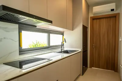 a kitchen with a sink and a window at Mouana Breeze Mai Khao 4-bedroom Pool Villa 9921 in Mai Khao Beach