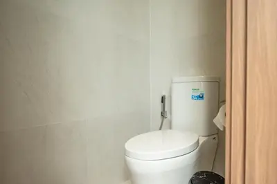 a bathroom with a white toilet in a room at Mouana Breeze Mai Khao 4-bedroom Pool Villa 9921 in Mai Khao Beach