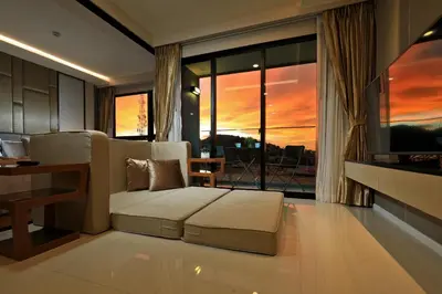 a living room with a couch and a table at 1bdr Modern Apartment Cozy Seaview Stay in Surin Beach