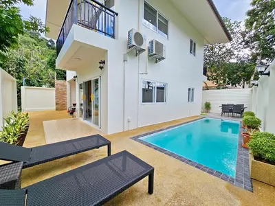 a swimming pool in the backyard of a house at The Green View Pool Villa in Kamala Beach