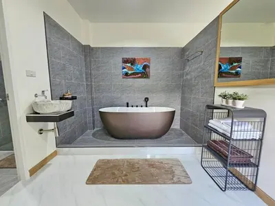 a bathroom with a tub and a sink at The Green View Pool Villa in Kamala Beach