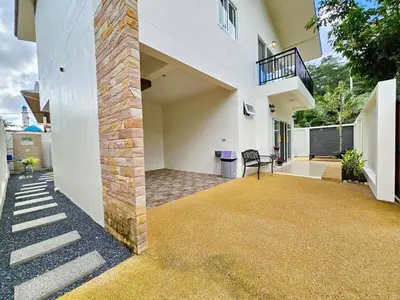 an external view of a white building with a balcony at The Green View Pool Villa in Kamala Beach
