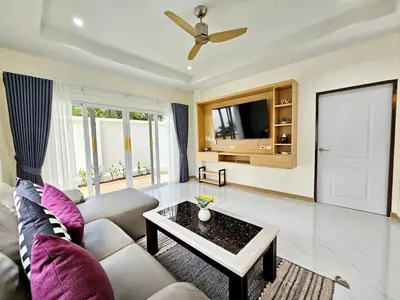 a living room with a couch and a table at The Green View Pool Villa in Kamala Beach