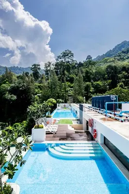 a pool on the roof of a building with trees at Kamala Modern 2 bedroom Apartment in Kamala Beach