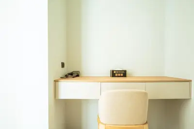 a desk with a chair and a clock on it at Mouana Breeze Mai Khao 4-bedroom Pool Villa 9920 in Mai Khao Beach