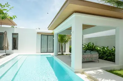 a swimming pool in the backyard of a villa at Mouana Breeze Mai Khao 4-bedroom Pool Villa 9920 in Mai Khao Beach