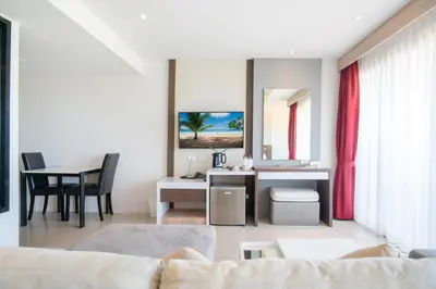 a living room with a couch and a table at Paripas Patong Resort in Patong Beach