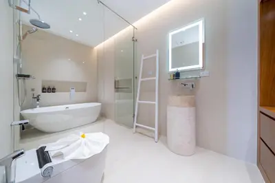 a white bathroom with a tub and a sink at The Trinity new modern 5BR villa with 20M Pool in Thalang