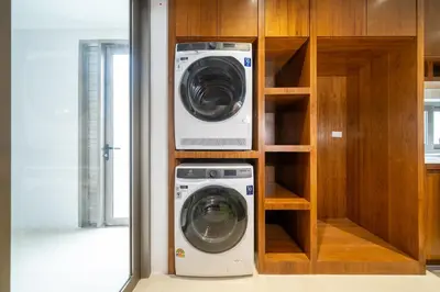 a washing machine and a washer in a closet at The Trinity new modern 5BR villa with 20M Pool in Thalang