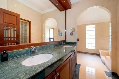 a bathroom with a sink and two mirrors at Laguna Lakeshore Villas Residence - Spacious Townhouse with Tropical Pool Access in Bang Tao Beach
